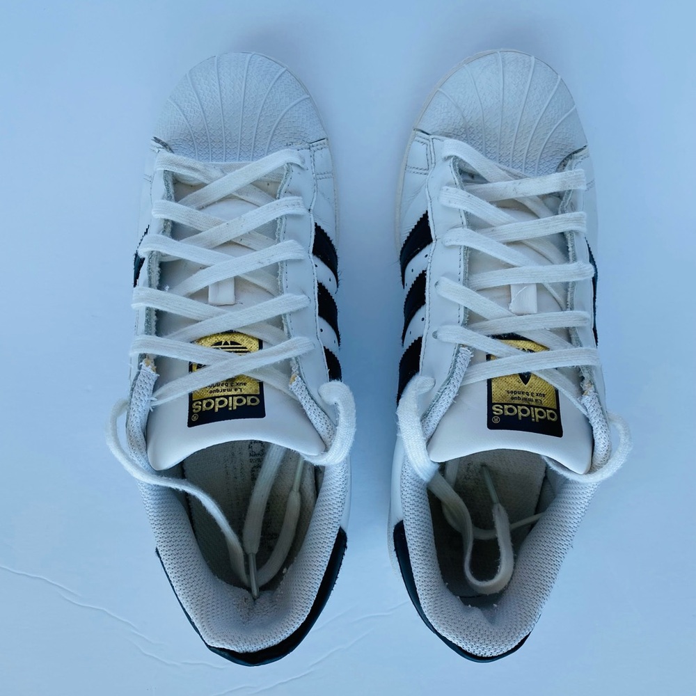 Adidas White and Black Superstar Sneakers with Gold Accents